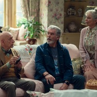 Eine Szene des Films "The Thursday Murder Club": Zwei ältere Herren und zwei ältere Damen in einem Wohnzimmer um ein Sofa versammelt