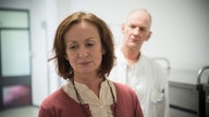 Anna steht bedrückt im Krankenhaus