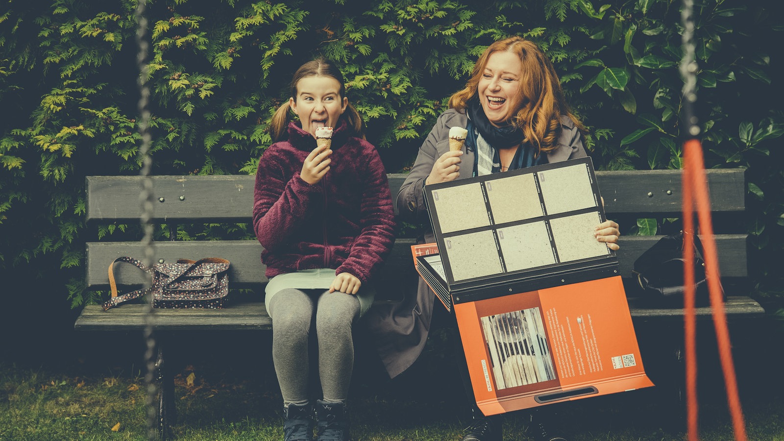 Antonia und Iffi sitzen auf einer Bank und essen Eis