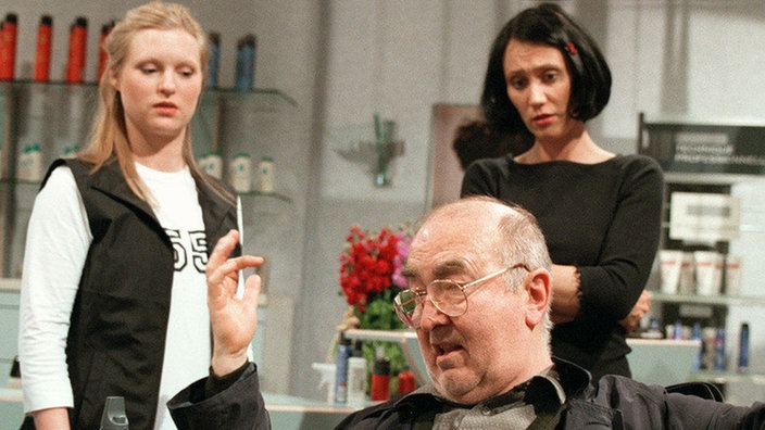 Der volltrunkene Dressler (Ludwig Haas) ist in den Friseursalon gerollt und wäscht Tanja (Sybille Waury, links) den Kopf - glücklicherweise nur im übertragenen Sinne. Urszula (Anna Nowak) sieht fassungslos zu.