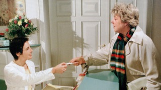 Ein hartnäckiger Schnupfen lenkt Helga Beimers (Marie-Luise Marjan, re) Schritte in Dresslers Vorzimmer. Dort lernt sie Frau Horowitz (Marita Ragonese), die neue Sprechstundenhilfe, kennen.