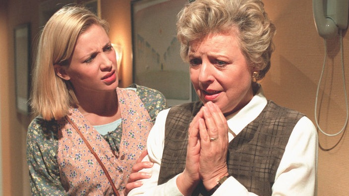 Helga (Marie-Luise Marjan, rechts) weiß nicht mehr, was sie denken soll. Pat (Dana Carlson) schlägt eine Aussprache mit Erich vor.