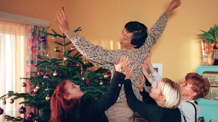 Iffi (Rebecca-Siemoneit-Barum, links), Valerie (Nadine Spruß) und Rosi (Margret van Munster, rechts) versuchen mit vereinten Kräften, Gung (Amorn Surangkanjanajai)  vor dem Absturz zu bewahren.