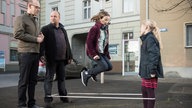 Klaus, Mila und Antonia spielen Gummitwist, Philipp steht daneben