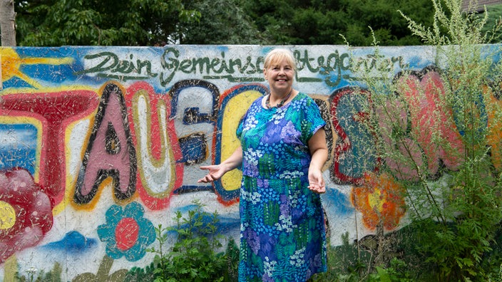 Elisabeth Schmelzer vor Schriftzug Tausendschön