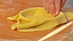 Mürbeteig wird in eine Tarte-Form gedrückt.