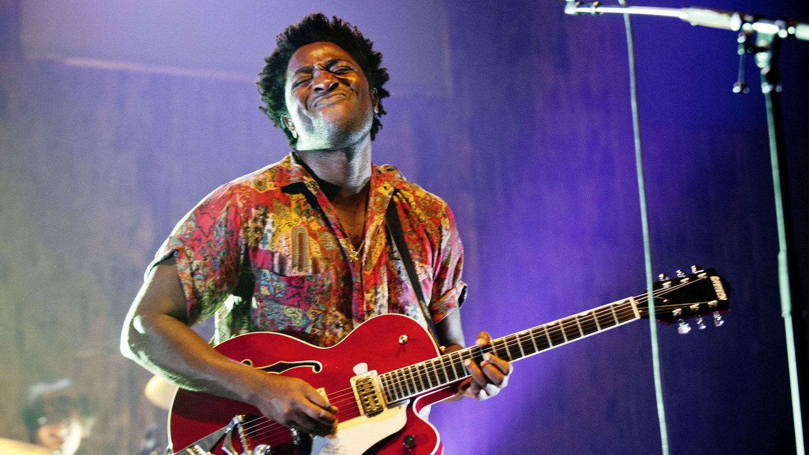 Frontmann von Blocparty spielt auf einer roten Gitarre und verzieht sein Gesicht.