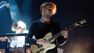Gitarrist spielt und schaut dabei auf seine Finger