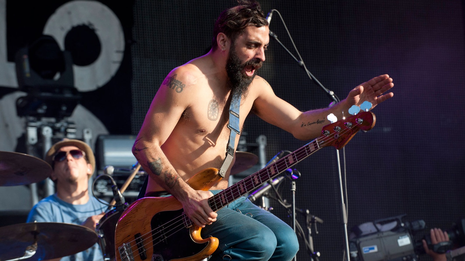 Der bärtige Bassist trägt eine blaue Hose