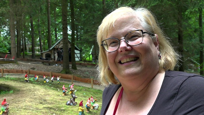 Eine Frau steht lächelnd im Freizeitpark Ibbenbüren