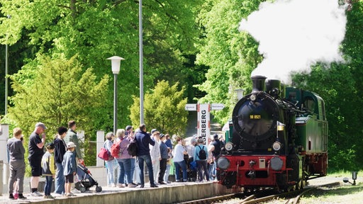 historische Eisenbahn Schluff läuft auf Bahnsteig ein