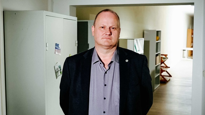 Michael Kutz, blau-graues Hemd und schwarzes Sakko, lichte, kurze Haare, blickt nach vorne in die Kamera