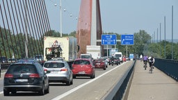 Autos und Radfahrer fahren über die Brücke