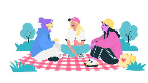Drei Frauen sitzen auf einer Picknickdecke und lachen.