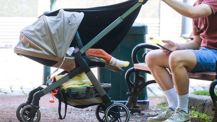 Ein Vater mit seinem Kind im Kinderwagen 