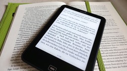 e-Book liegt auf einem Buch