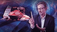 Dr. Eckart von Hirschausen hält eine Spritze in der Hand