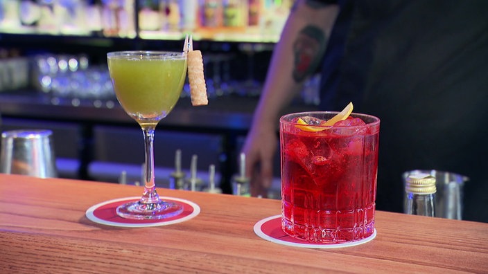 Zwei Cocktails stehen auf der Theke einer Bar