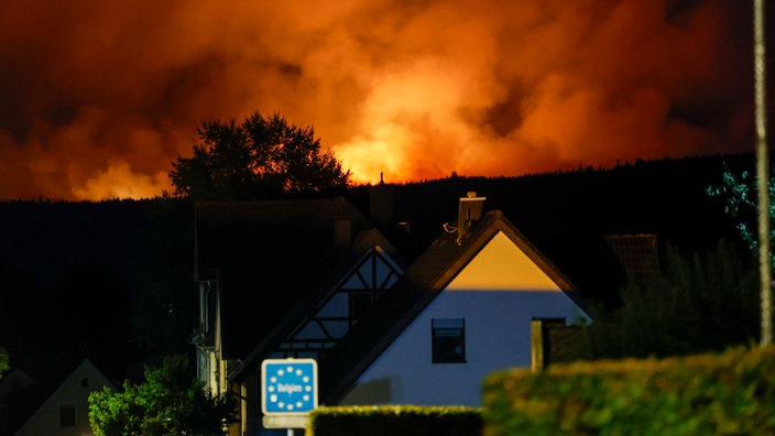Blick von dem Ortsteil Monschau-Kalterherberg auf die belgische Seite, wo das Hohe Venn in Flammen steht.