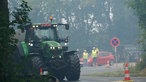 Ein Traktor auf der verrauchten Straße beim Hohen Venn
