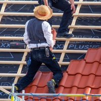Dachdecker beim Eindecken eines Ziegeldaches