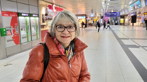 Eine Frau steht im Düsseldorfer Hauptbahnhof