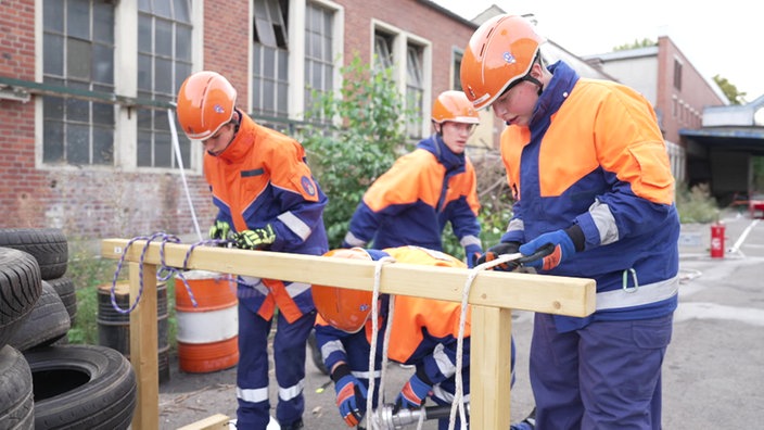 Drei Mitglieder der Jugendfeuerwehr während einer Knotenübung