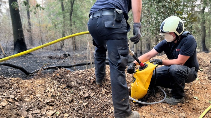 Zwei Einsatzkräfte bei den Löscharbeiten im Hürtgenwald