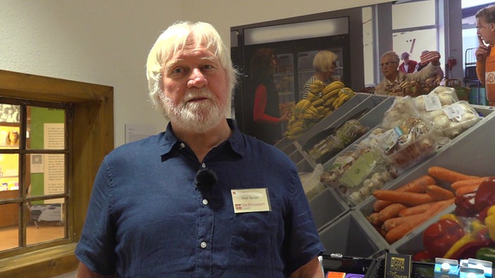 Der Organisator der Ausstellung schaut in die Kamera