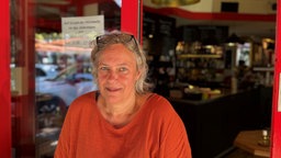 Claudia Philippen vor einer Gastronomie.