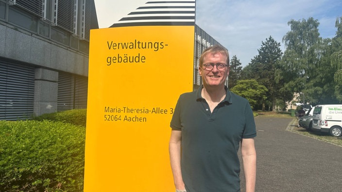 Städtischer Mitarbeiter Jens Hasse vor dem Gebäude der Stadtverwaltung Aachen 
