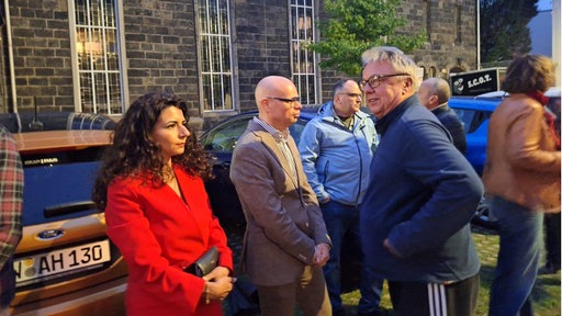 Mehrere Menschen versammeln sich vor der Barmer Synagoge