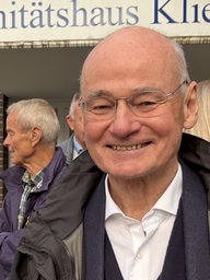 Detlef Schildbach vor einer Gruppe Menschen