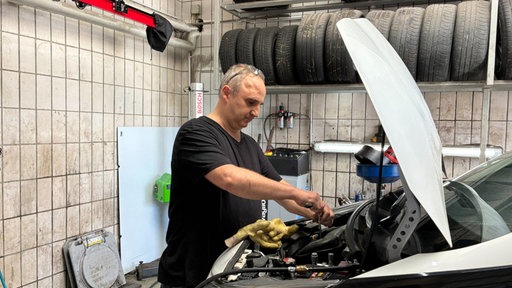Automechaniker Paul Rill bei der Arbeit