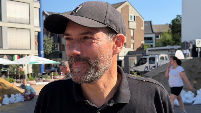 Herr mit schwarzer Käppi bei den Vorbereitungen des Haaner Sommerfestes