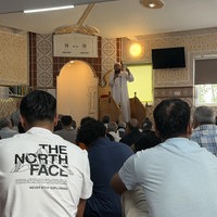 Männer sitzen in einer Moschee.