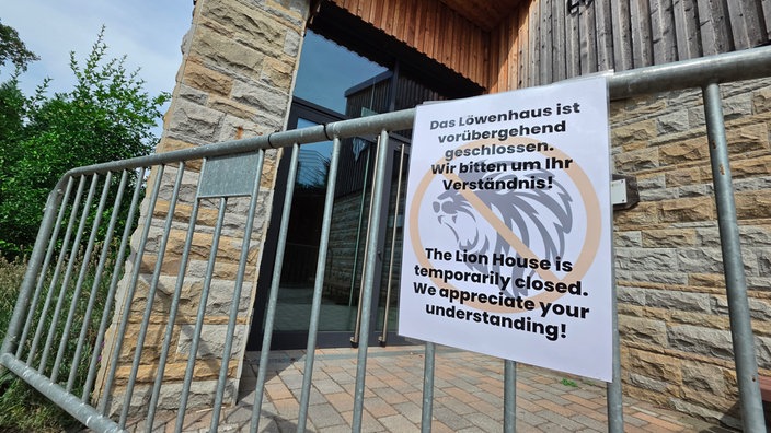 Ein Schild auf dem steht "Das Löwenhaus ist vorübergehend geschlossen" hängt an einer Absperrung im Dortmunder Zoo