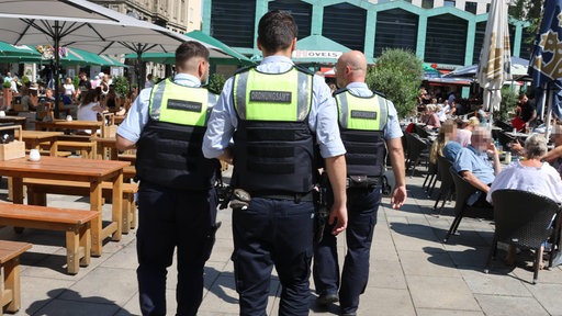 Mitarbeiter des Ordnungsamtes gehen über den Alten Markt in Dortmund