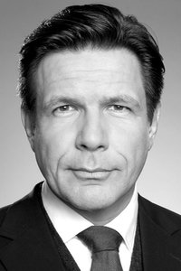 Ein Mann im Anzug schaut in die Kamera