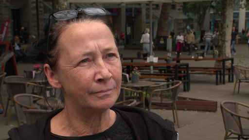Corinna steht in der Essener Innenstadt vor einem Lokal.
