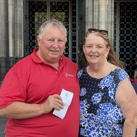 Roslyn und Tony aus Australien stehen mit Ticket vor dem Kölner Dom
