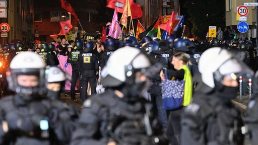 Teilnehmer (hinten) werden bei einem "Anti-Kriegs-Marsch" der Initiative "Rheinmetall Entwaffnen" durch die Polizei eingekesselt. 