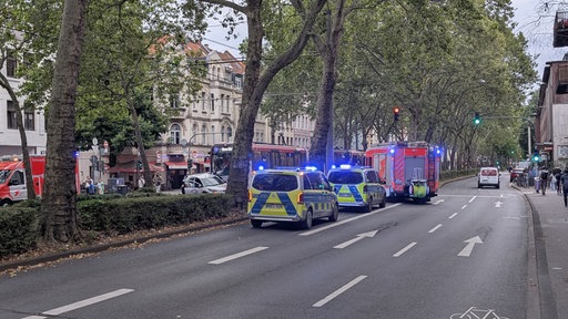 Einsatzfahrzeuge von Polizei und Rettungswägen stehen rund um die Unfallstelle in Köln-Sülz