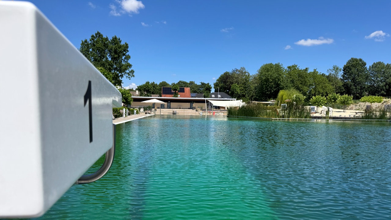 Das Freibad Ennigerloh im Sonnenschein. Links ein Startblock mit der Nummer 1.