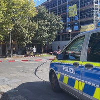 Ein Polizeifahrzeug am Hamannplatz in Münster Coerde vor einem abgesperrten Bereich.