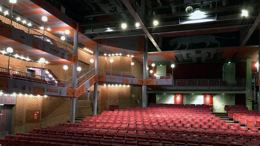 Archivmaterial: Theatersaal mit den roten Stühlen aus Perspektive der Bühne