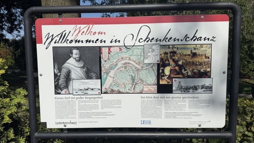 Ein Schild mit der Aufschrift "Willkommen in Schenkenschanz". Darunter einige Bilder.