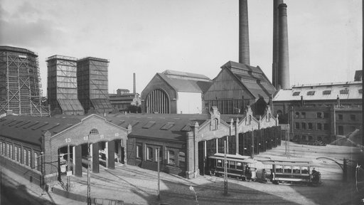 Auf dem Bahnhofsvorplatz steht ein Wagen.