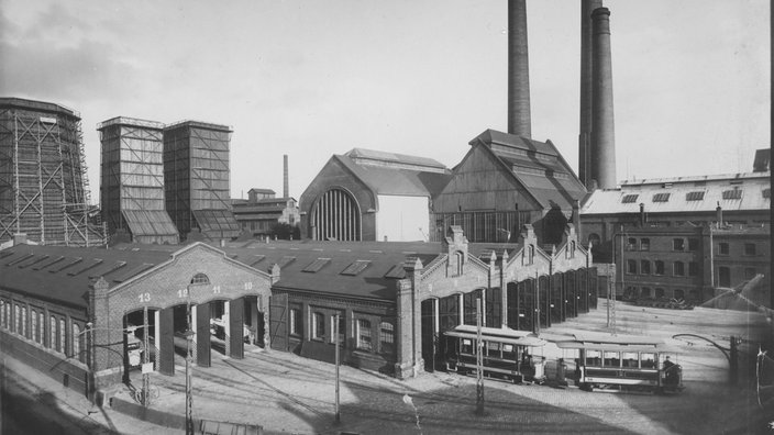 Auf dem Bahnhofsvorplatz steht ein Wagen.
