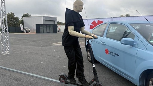 Crashtest-Dummy auf einem E-Scooter